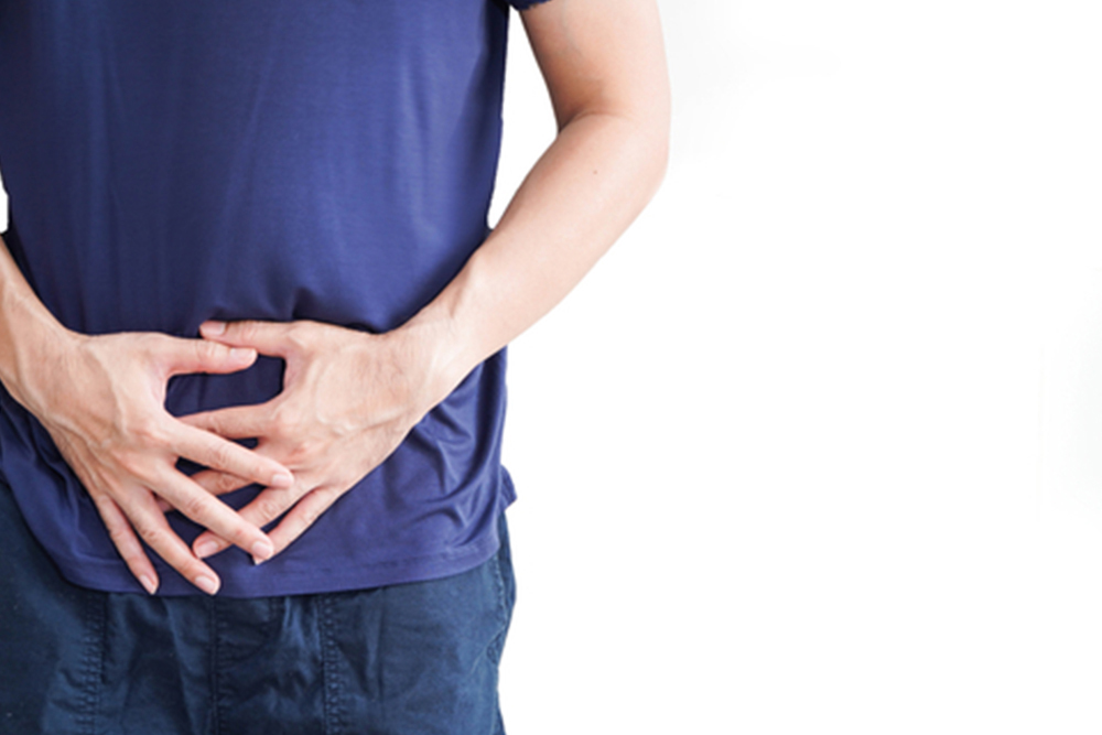 Man with stomach pain on white background